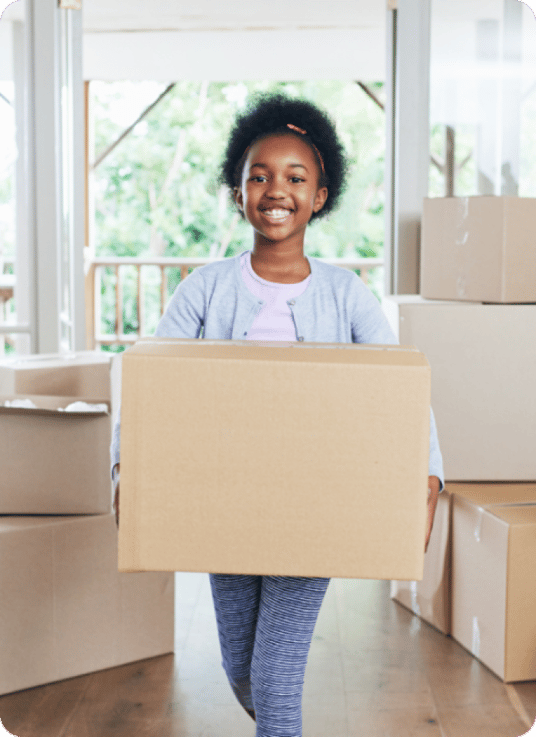 Happy child with boxes ready to move into new home